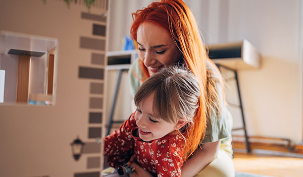 Woman and child with dolls house
