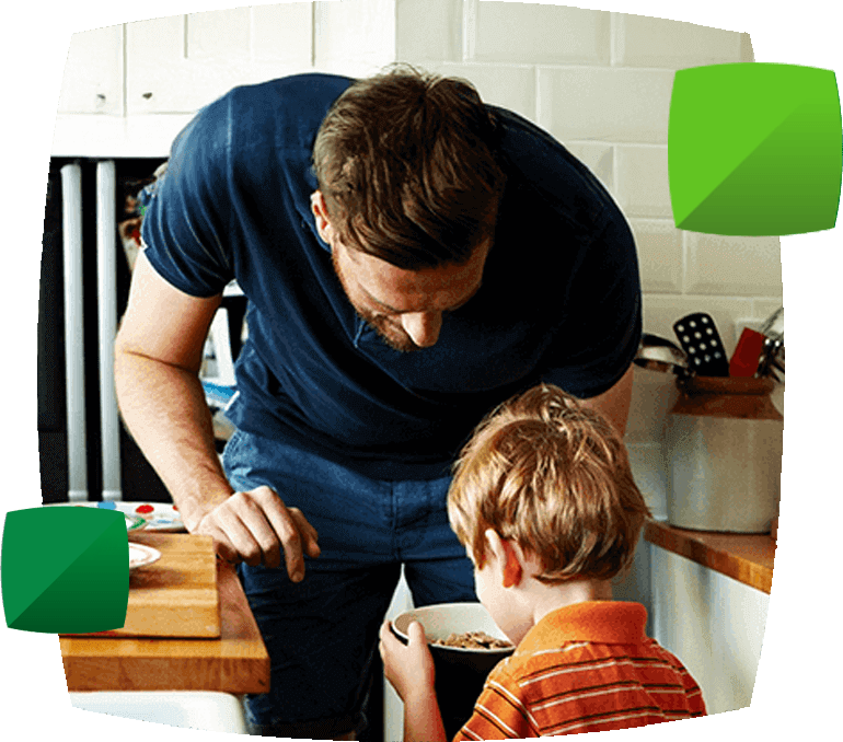 man handing breakfast bowl to child