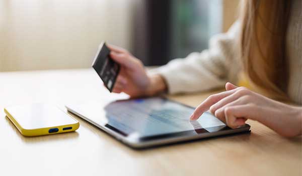 Person using credit card via tablet device