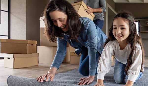 mother and daughter rolling rug