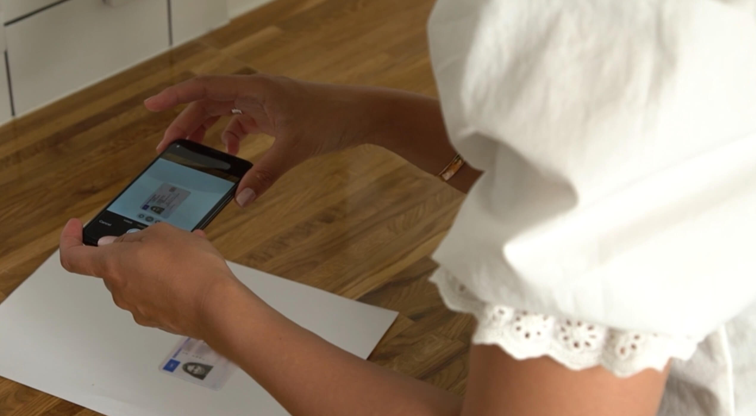 Person taking a picture of their ID