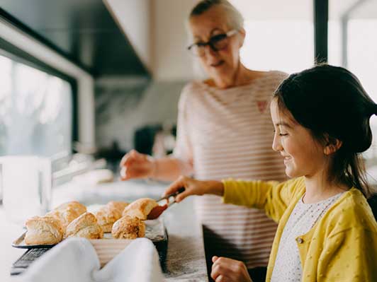 Grandmother and granddaughter baking