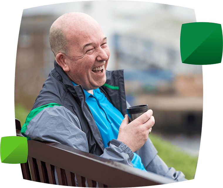 Man enjoying a drink on a bench
