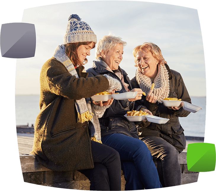 Women socialising and eating fish and chips