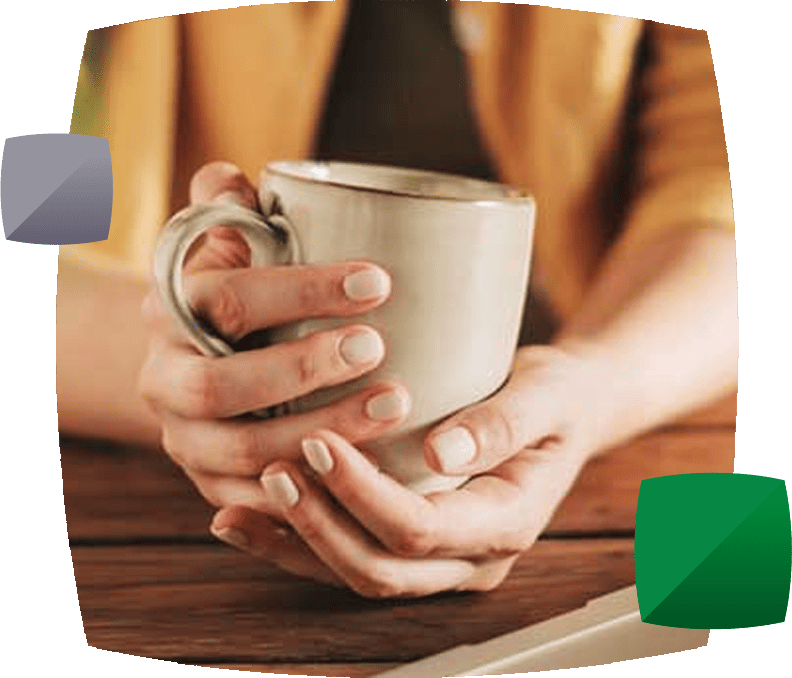 Persons hands holding mug