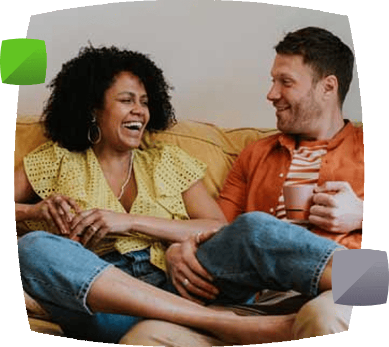 Couple on sofa with cup of tea
