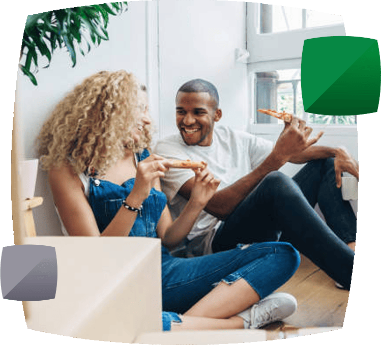 couple sat with boxes eating pizza