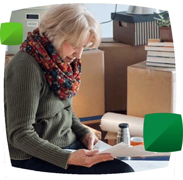 woman sitting with boxes holding papers