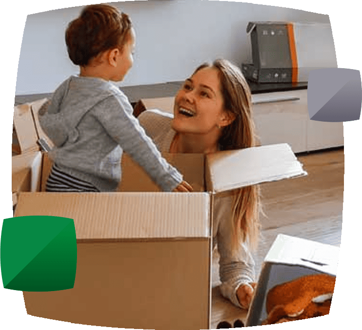 Boy playing in box with parent