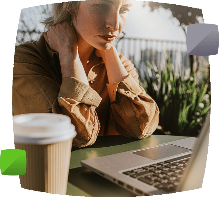 Woman sat at laptop with coffee