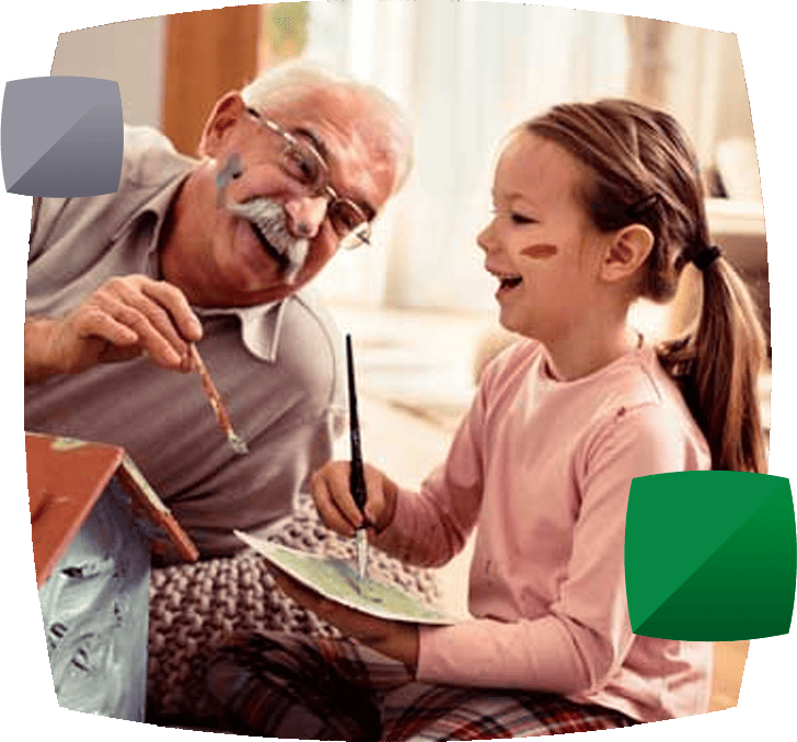 Grandfather and grandchild playing painting a doll's house