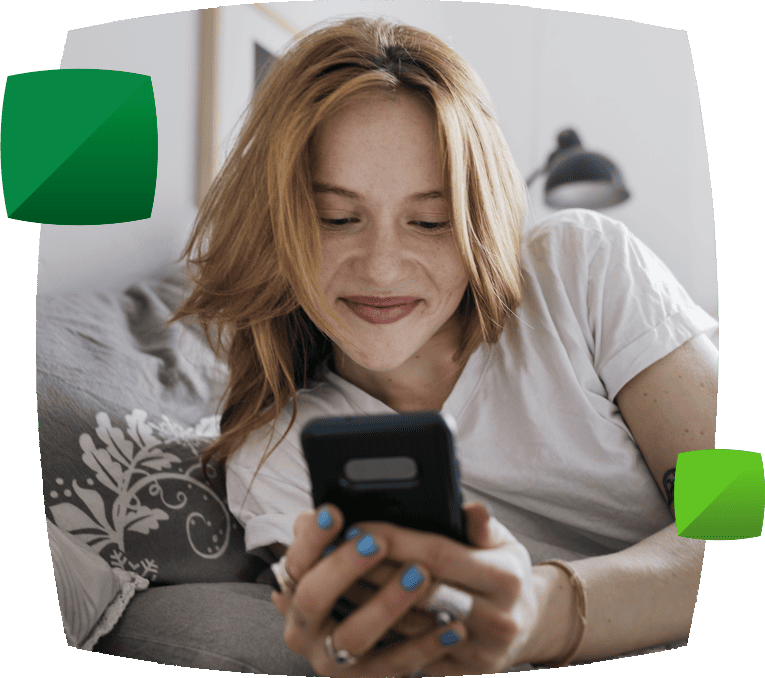 woman smiling looking at phone